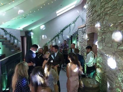 Tom Ryder with Gareth and Millie at their wedding at Trevenna in Cornwall